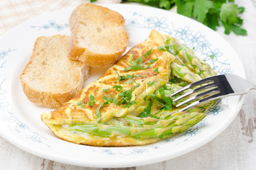 omelette with asparagus, greens and toast horizontal close-up
