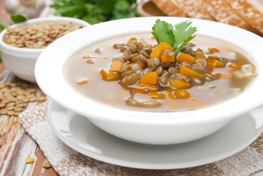 plate of vegetable soup with lentils, close-up