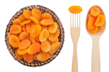 Spoon, a fork, a plate with dried apricots