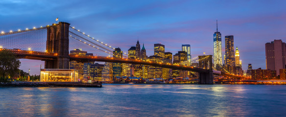 Panorama of Brooklyn Bridge with lights and reflections
