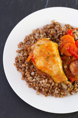 chicken with buckwheat on white plate
