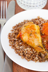 chicken with buckwheat and sauce on plate