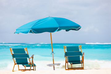 Chairs and umbrella on tropical beach