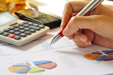 coffee and cookie on financial statements and line chart.