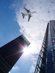 Fototapeta na wymiar airplane flying over buildings