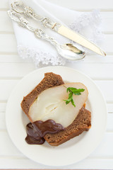 Chocolate cake with pears and chocolate sauce.