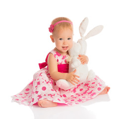 little baby girl hugging a  toy bunny rabbit isolated on white