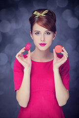 Redhead girl with macaron for St. Valentine Day.