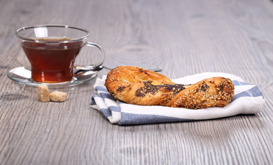bun with poppy seeds and teacup