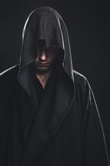 Fototapeta premium Portrait of man in a black robe