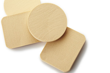 Make-up sponges in different sizes, on a white background