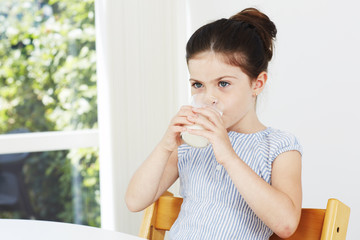 Young girl drinking milk