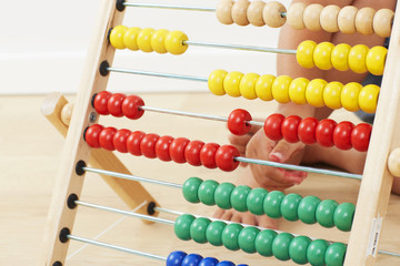 Young boy playing with abacus, close up
