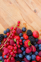 pile of fresh red and blue berries on table