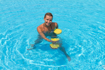 Woman is engaged aqua aerobics in water