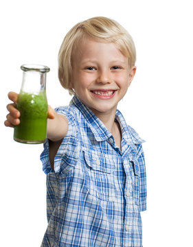 Happy boy holding bottle of green smoothie
