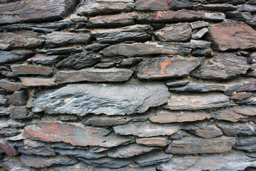 Stone texture background (rustic wall made of many piled stones)