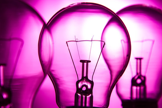 Row of light bulbs on a bright pink background