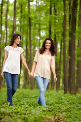 Mother and daughter walking hand in hand