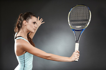 Female tennis player preparing to execute a backhand volley