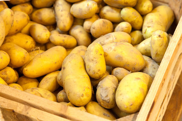 Fresh potatoes in a wooden crate.