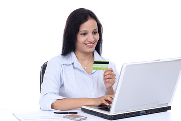 Happy young business woman doing online shopping
