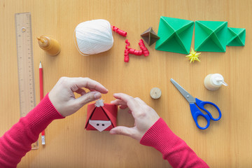 Female hands making Christmas decorations