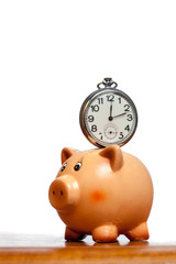Pocket watch on a piggy bank