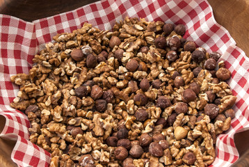 Salted roasted hazelnuts and walnuts in bowl