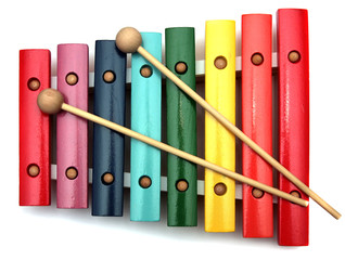 colorful, wooden xylophone with mallet over white