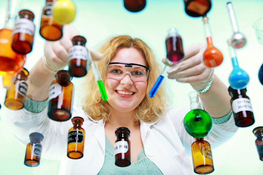 chemist woman with chemical glassware tubes
