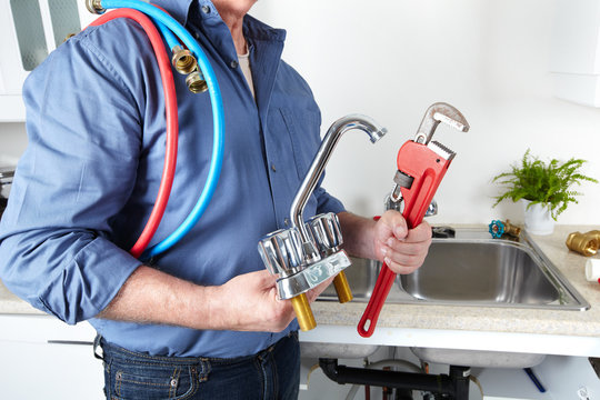 Plumber with a wrench.