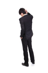 Rear view of young business man confused