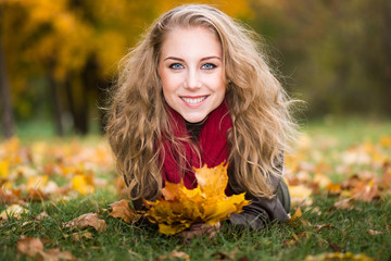 Young woman with autumn leaves