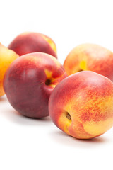 Ripe peaches fruits isolated on white