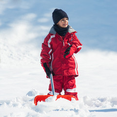 Fototapeta na wymiar Young kid with shovel outdoors.