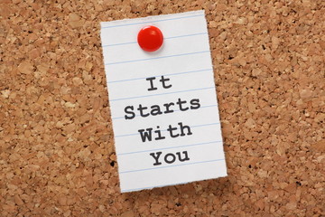 It Starts with You typed on paper on a cork notice board