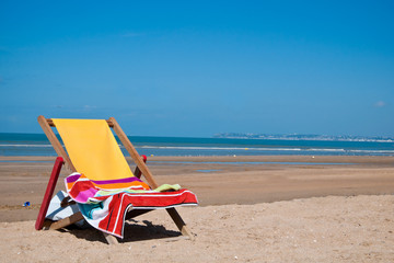 Fototapeta na wymiar Beach chair and beautiful beach on a sunny day