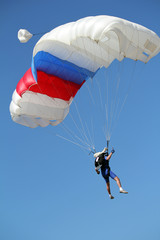 extreme sport parachutist on blue sky