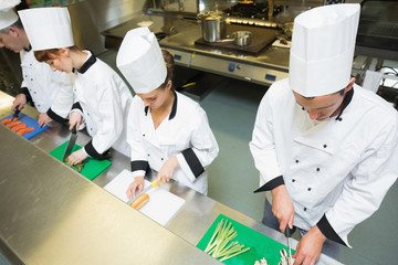 Naklejka premium Four chefs preparing food at counter