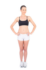Fototapeta premium Fit woman in sportswear and hands on hips looking away