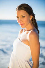 Fototapeta na wymiar Peaceful brunette in white summer dress posing