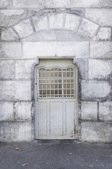 Old metal door in a stone wall