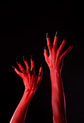 Obraz premium Spooky red demonic hands with black nails, real body-art
