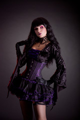 Romantic gothic girl in purple and black gothic Halloween outfit