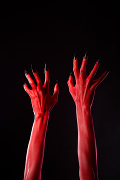 Red demonic hands with black nails, real body-art