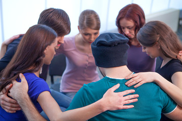 Group of people sitting in a circle.