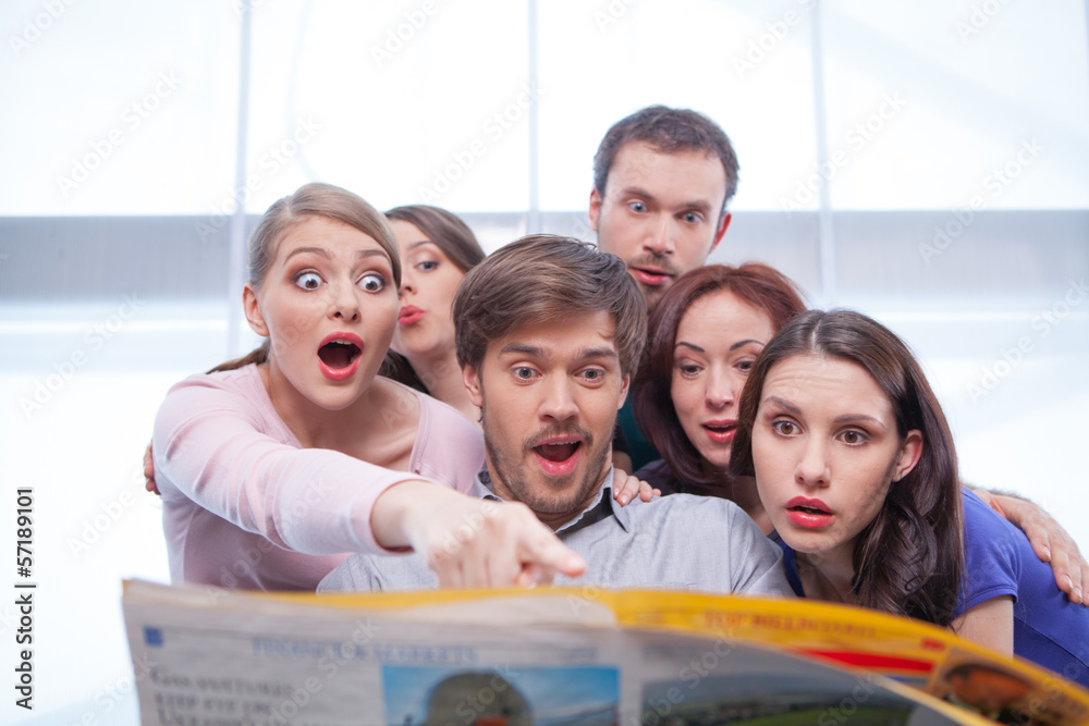 Wall mural group of young people reading newspaper.