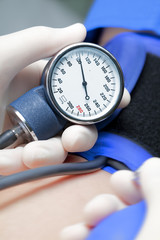 blood pressure of the patient. The doctor measuring blood pressu