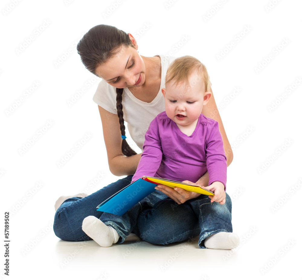 Fototapete mother reading a book to her baby daughter